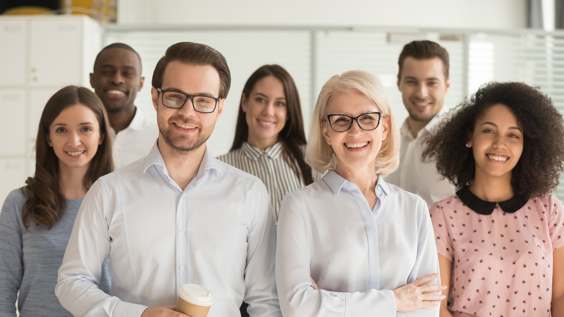 Smiling professional business leaders and employees group team portrait